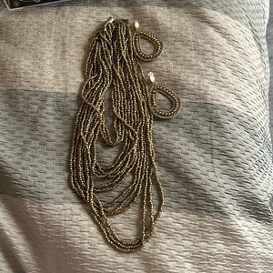 Gold beaded multi strand necklace and earrings.